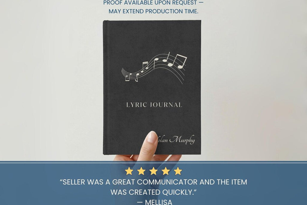 A hand holding a black lyric journal with white musical notes and the title 'LYRIC JOURNAL' on the cover, set against a light background with promotional text banners above and below.